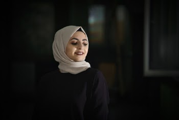 Photo of Smiling Woman in Hijab Posing While Looking Away 