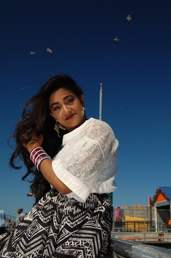 Photo of Smiling Woman Leaning on Metal Railing Posing