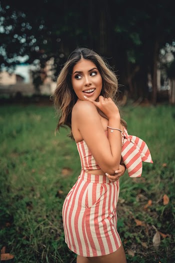 Photo of Smiling Woman Looking over Her Right Shoulder Posing