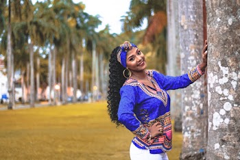 Photo of Smiling Woman Posing by Palm Tree