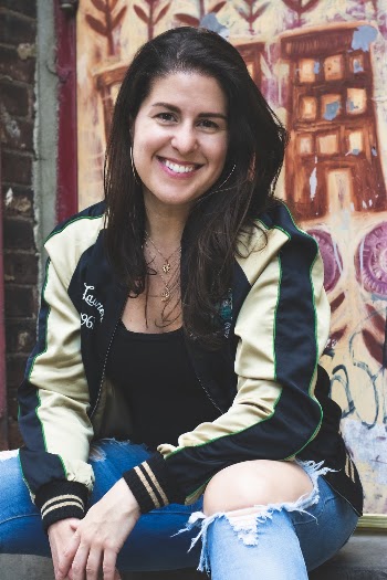 Photo of Smiling Woman Sitting In Front Painted Wall
