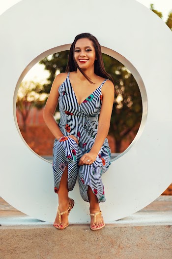 Photo of Smiling Woman Sitting on O Freestanding Letter