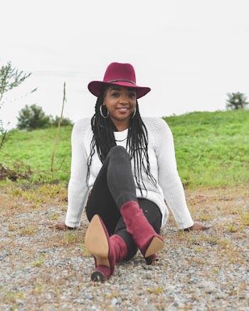 Photo of Smiling Woman Sitting on the Ground