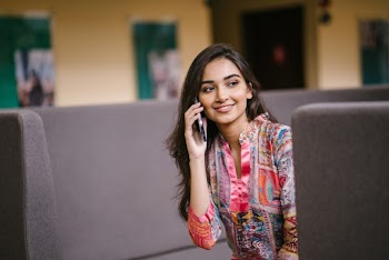 Photo of Smiling Woman Talking on Phone
