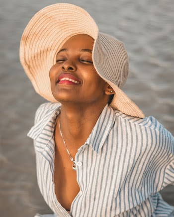 Photo of Smiling Woman Wearing Beige Hat