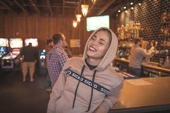 Photo of Smiling Woman Wearing Pullover Hoodie