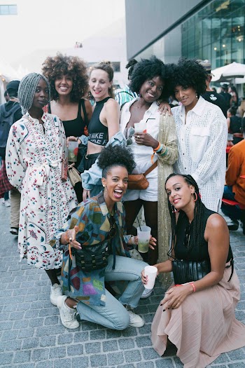 Photo of Smiling Women Posing for a Group Photo