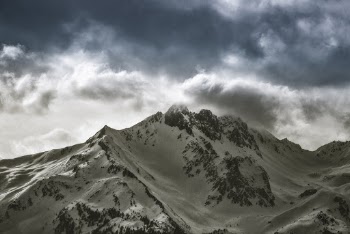 Photo of Snow Capped Mountain Under Cloudy Sky