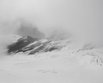 photo of snowfield and mountain alps