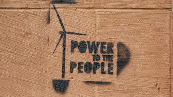 Photo of Spray Painted "Power to the People" Sign on Brown Wall