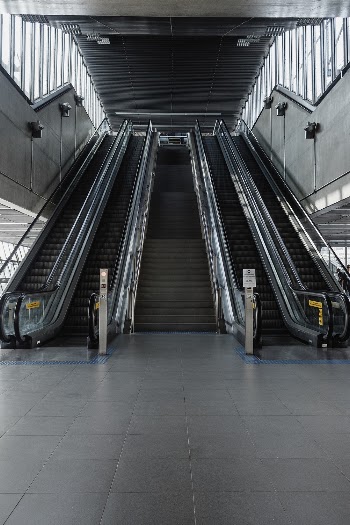 Photo of Stairs Between Escalators