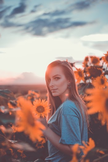 Photo Of Standing Near Sunflowers