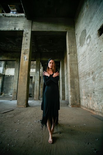 Photo of Standing Woman in Black Dress Walking Barefooted in Abandoned Building
