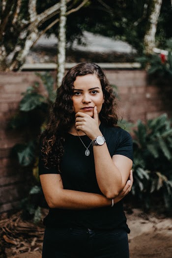 Photo of Standing Woman in Black T-shirt and Jeans Posing