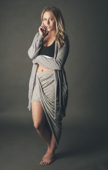 Photo of Standing Woman Posing In Front of Gray Background