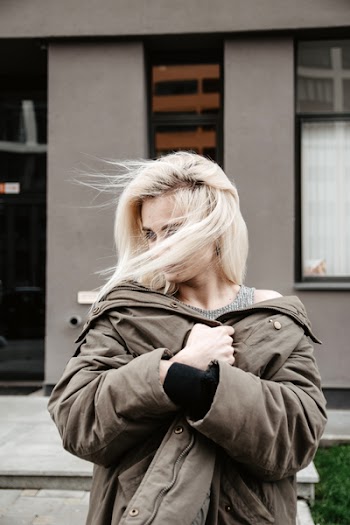 Photo of Standing Woman Wearing Brown Coat with Her Hair Covering Her Face