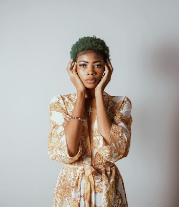 Photo of Standing Woman With Green Hair With Both Hands on Face