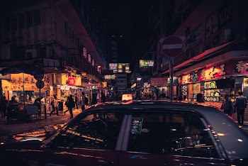 Photo of Taxi Near Buildings During Nighttime