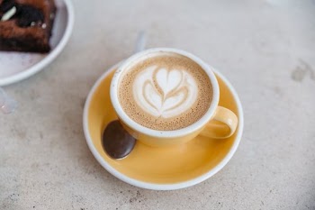 photo of teacup filled with latte