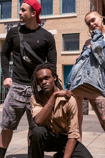 Photo of Three People Posing Outdoors