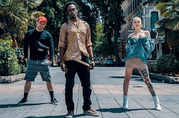 Photo of Three People Standing on Pavement