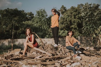 Photo of Three Persons On A Pile Of Scraps