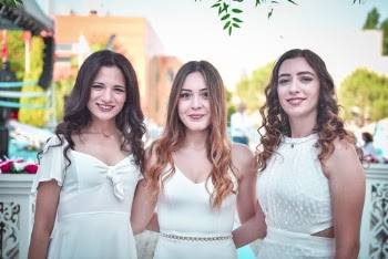 Photo of Three Smiling Women in White Dress Standing Together
