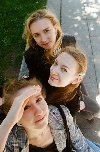 Photo of Three Women Sitting Outdoors