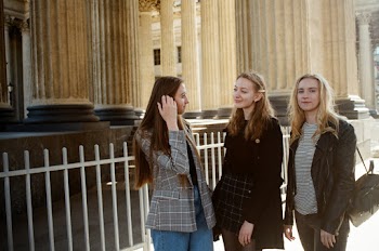 Photo of Three Women Standing Near Building