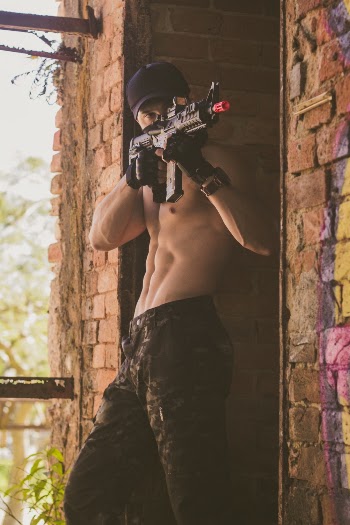Photo of Topless Man Using Rifle Airsoft