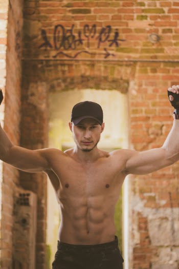 Photo of Topless Man Wearing Black Cap