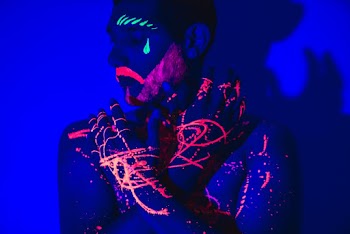 Photo of Topless Man With Body and Face Art