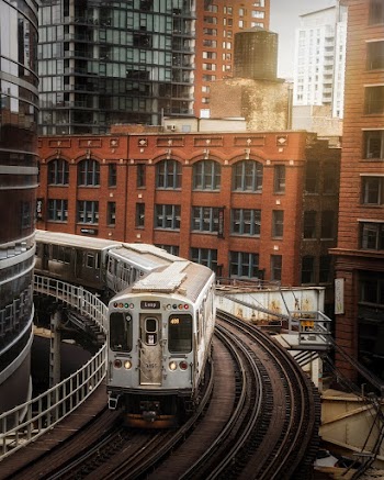 Photo of Train in Railway Track Near Buildings