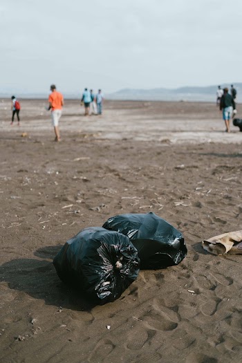 Photo Of Trash Bag On Sand