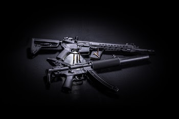 Photo of Two Black Assault Rifles, Knife, and bullets