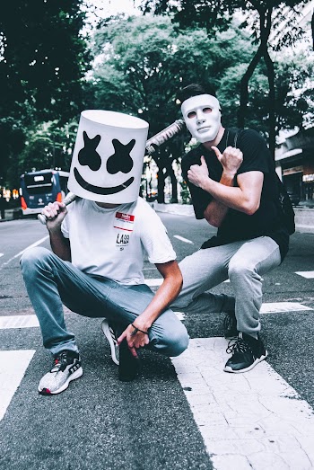 Photo of Two Men in Masks Squat Posing