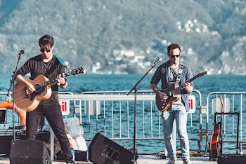 Photo of Two Men Playing Guitar