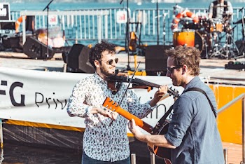 Photo of Two Men Playing Stringed Instrument