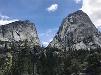 Photo of Two Mountains Beside Green Trees