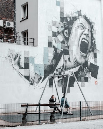 Photo of Two People Sitting on Swings