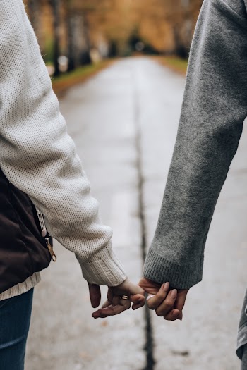 Photo of Two Persons Holding Hands