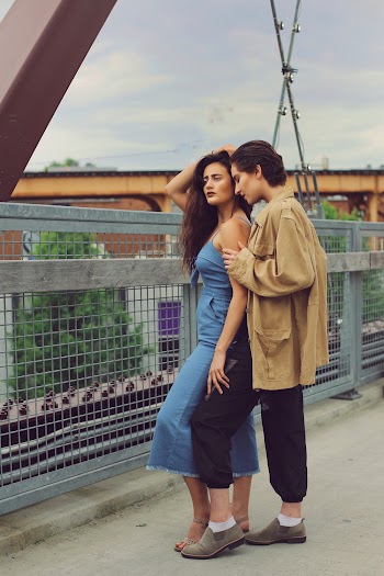 Photo of Two Persons Standing on Bridge