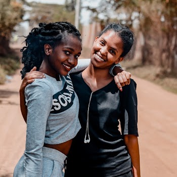 Photo of Two Smiling Women Standing Together