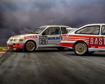 Photo of Two White-and-red Race Cars