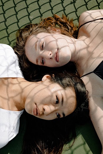 Photo Of Two Women Lying On Ground