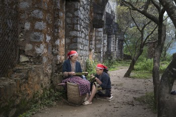 Photo of Two Women Sitting and Smiling