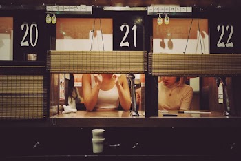 Photo of Two Women Sitting Beside Each Other