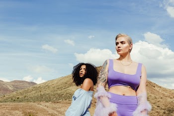Photo of Two Women Standing Near Mountain