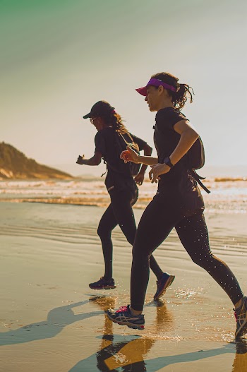 Photo of two women walking on shore