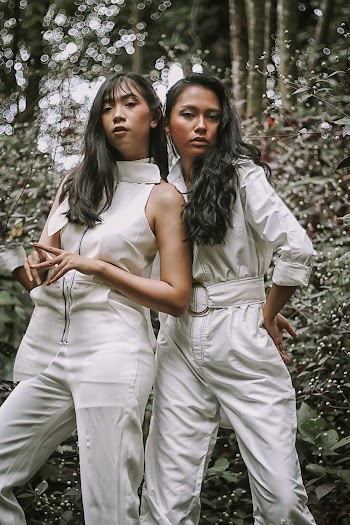 Photo of Two Women Wearing White Jumpsuit